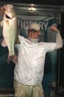 Angler holding a large bass with Easy View Tackle System visible in the boat