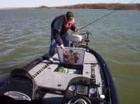 Angler retrieving a fishing bait quickly from Easy View Tackle System while on the water